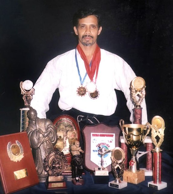 Grand Master M.H.M Iqbal, founder of Kei Zoku Hou Kickboxing and the World Martial Arts Association, with his medals and trophies